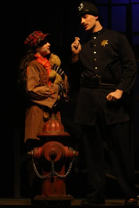 Tyler Walker as Officer Lockstock in Urinetown